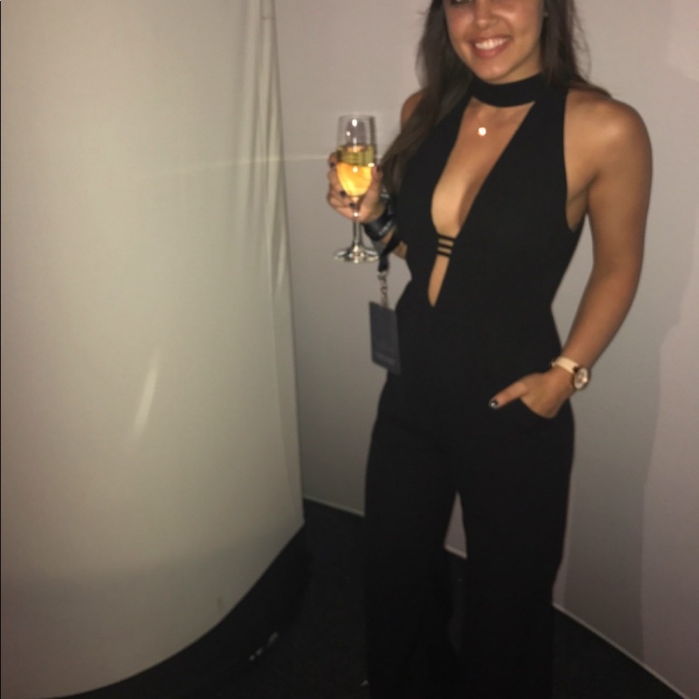 Wide leg flowy jumpsuit, high next but low cut, buttons around neck.